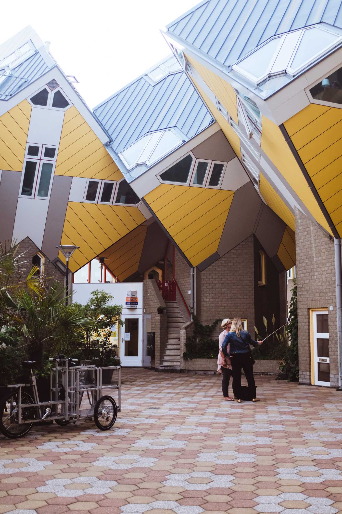 Two women take a selfie in the Cube Houses of Rotterdam
